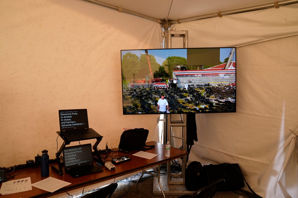 A tent at a Trump campaign rally shows a video monitor after he was the target of an assassination attempt. Photo: AP