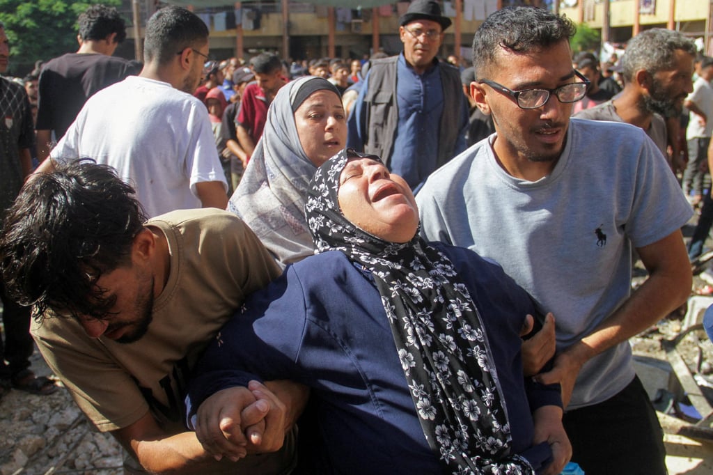 Palestinians at the site of an Israeli strike on a school sheltering displaced people. Most of Gaza’s 2.4 million people have been displaced at least once by the war. Photo: Reuters Palestinians at the site of an Israeli strike on a school sheltering displaced people. Most of Gaza’s 2.4 million people have been displaced at least once by the war. Photo: Reuters