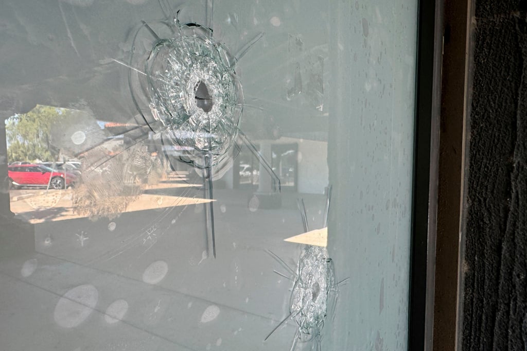 Bullet holes in the window at a Democratic Party campaign office in Tempe, Arizona. Photo: AP