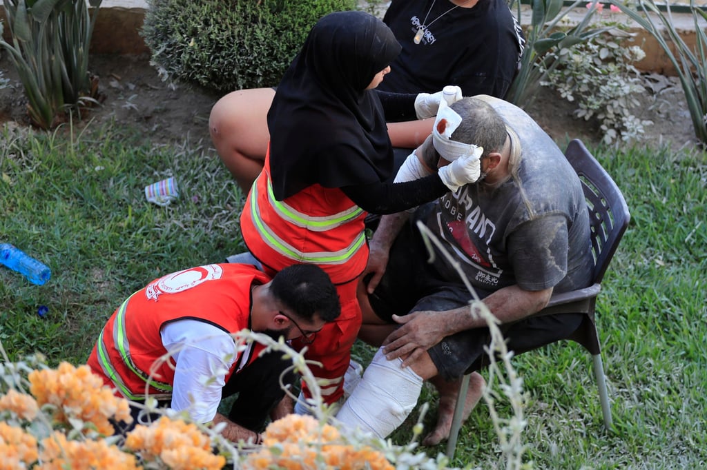 Paramedics treats a man who was injured after an Israeli strike east of the southern port city of Sidon, Lebanon on Sunday. Photo: AP