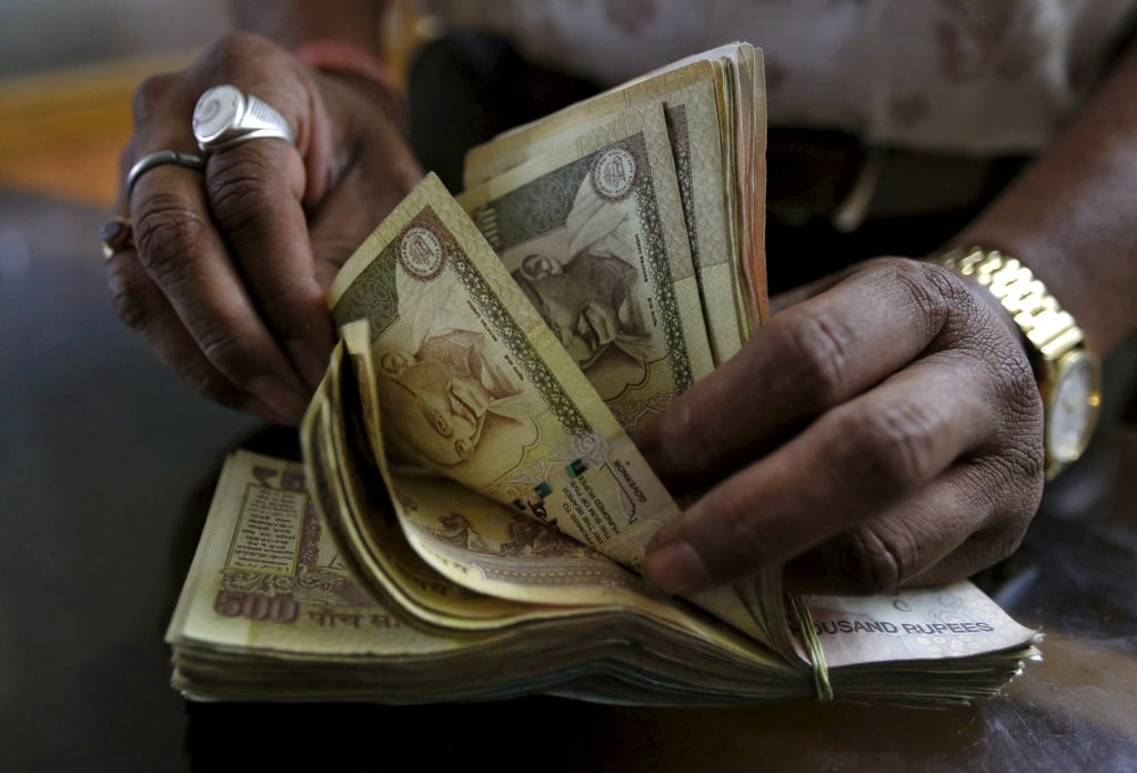 A man counts rupee notes. The incident has reignited debates about ticket scalping practices in India. Photo: Reuters