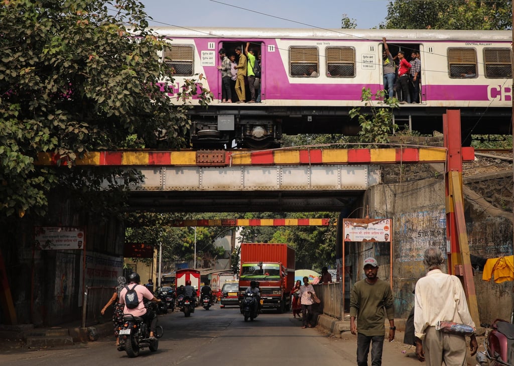 A local train passes over a street in Mumbai. Critics say the heavy focus on road expansion sidelines other forms of transport. Photo: Getty Images A local train passes over a street in Mumbai. Critics say the heavy focus on road expansion sidelines other forms of transport. Photo: Getty Images