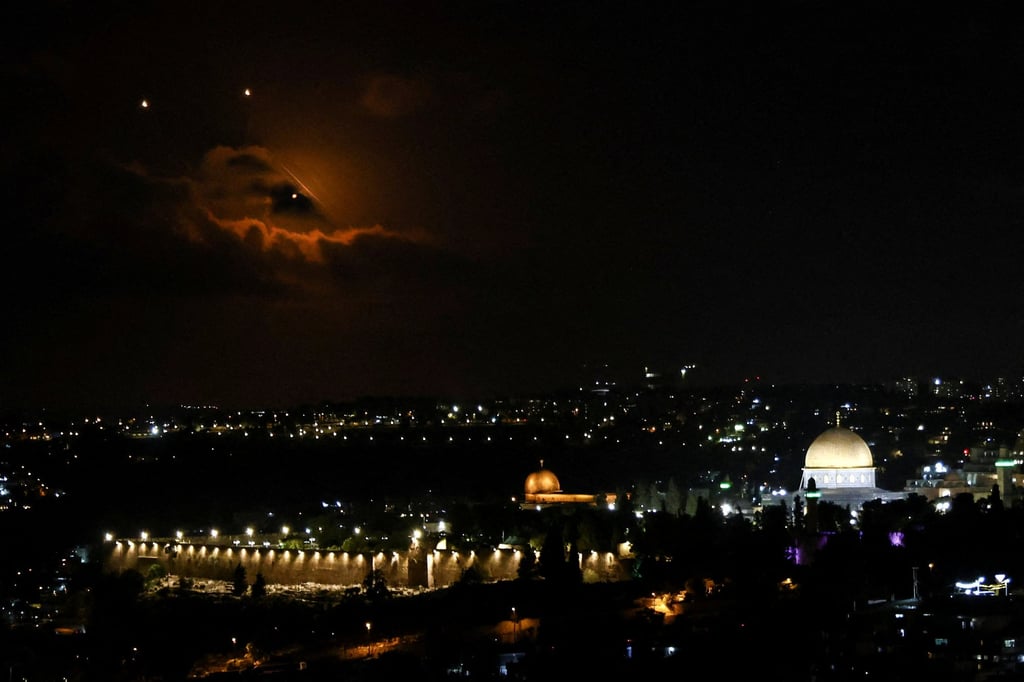 Projectiles fly through the sky, as seen from Jerusalem. Photo: Reuters Projectiles fly through the sky, as seen from Jerusalem. Photo: Reuters