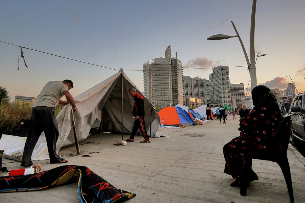 A Lebanese family who fled Beirut’s southern suburb erects a makeshift tent on Saturday. Photo: dpa A Lebanese family who fled Beirut’s southern suburb erects a makeshift tent on Saturday. Photo: dpa