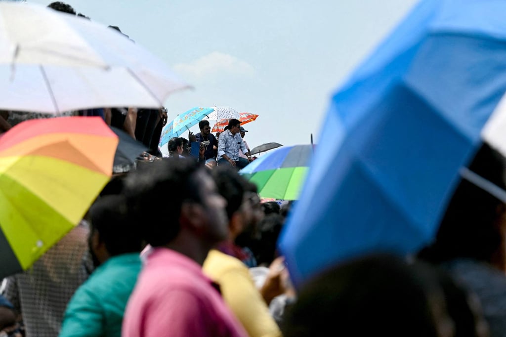 Spectators at Marina Beach in Chennai watch aircraft perform during Sunday’s air show. Photo: AFP Spectators at Marina Beach in Chennai watch aircraft perform during Sunday’s air show. Photo: AFP