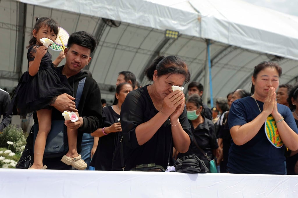 People offer their final respects at the cremation for victims of a school bus fire. Photo: AP People offer their final respects at the cremation for victims of a school bus fire. Photo: AP
