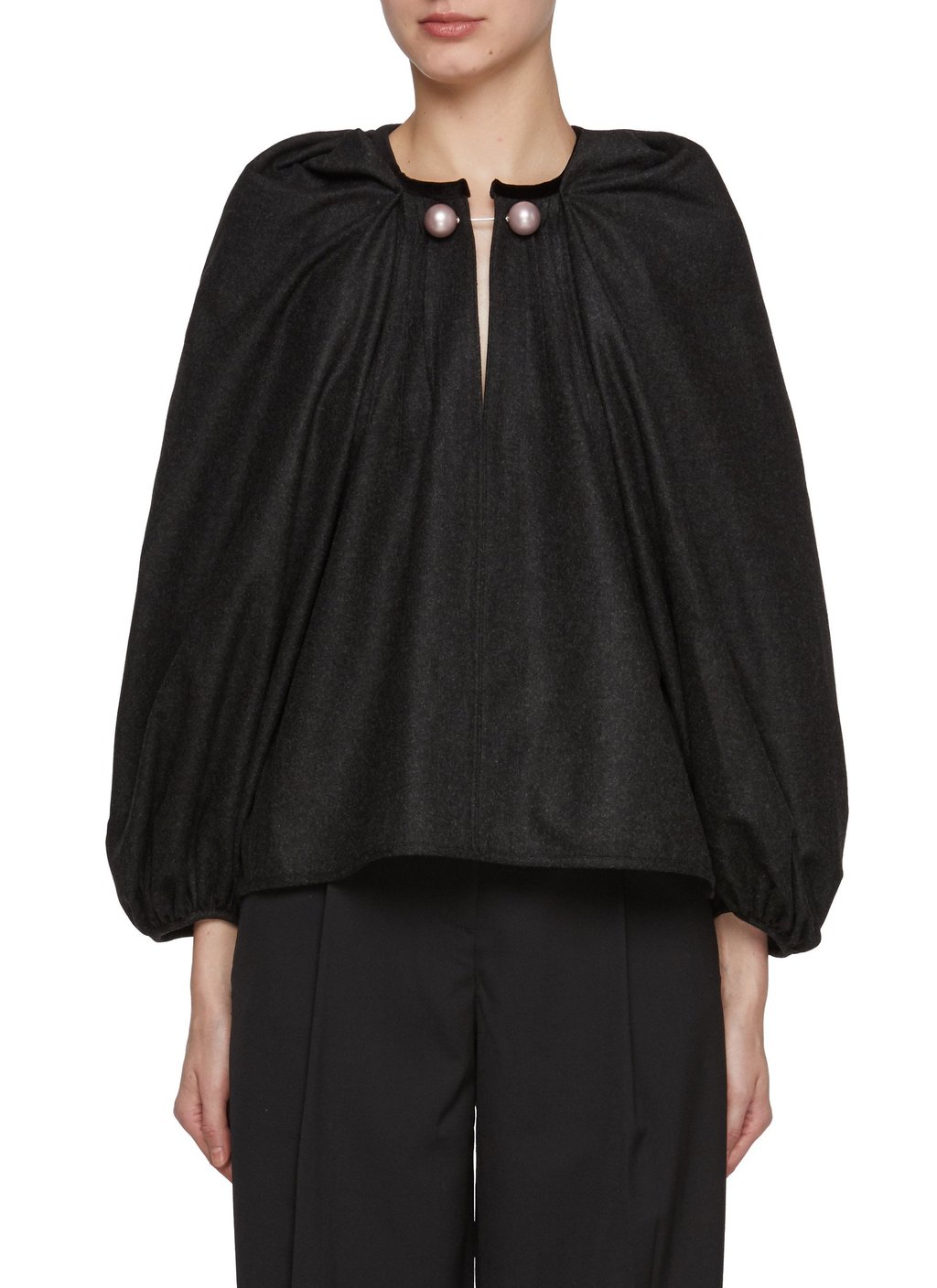 Nackiye’s designs, like the Draped V-Neck Pin Top in black, are built on the Turkish spirit Nackiye’s designs, like the Draped V-Neck Pin Top in black, are built on the Turkish spirit