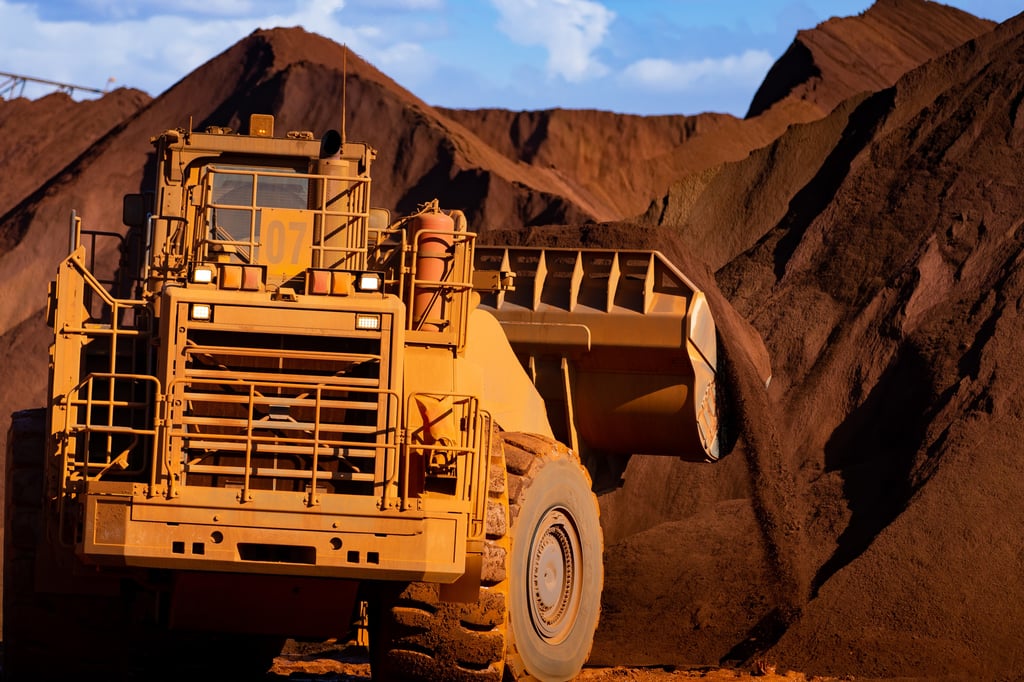Excavators move iron ore in Port Hedland, Australia. Photo: Bloomberg Excavators move iron ore in Port Hedland, Australia. Photo: Bloomberg