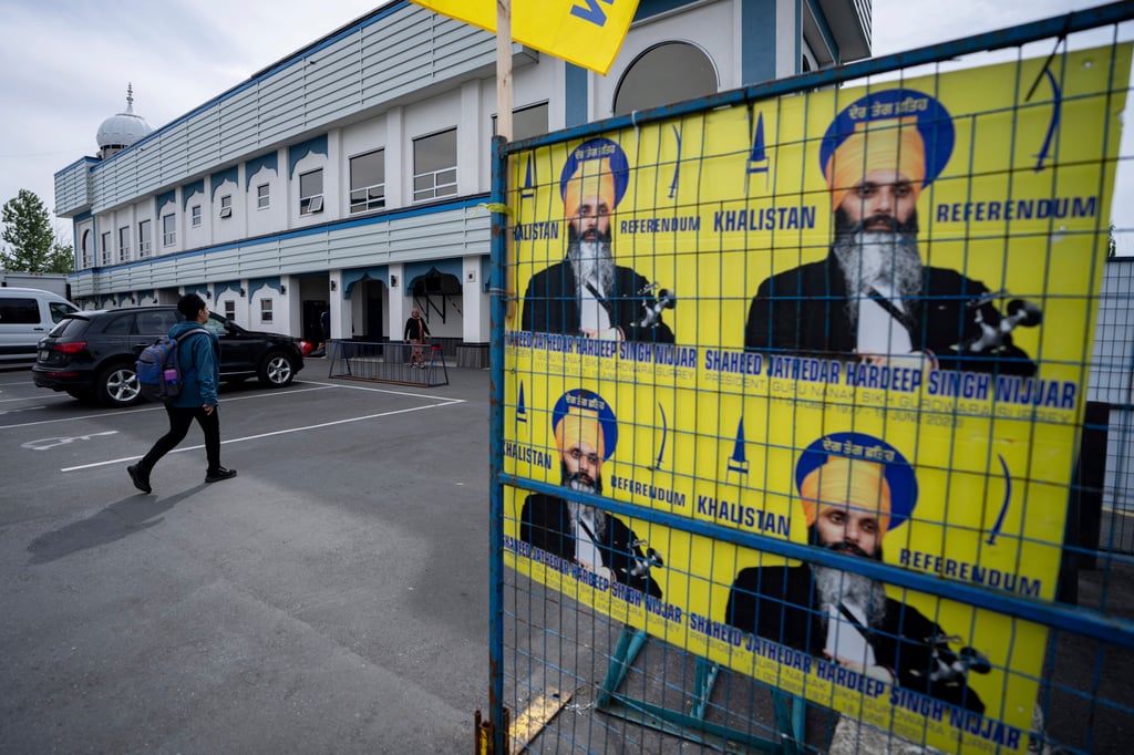 A person walks past posters of Hardeep Singh Nijjar in British Columbia, Canada, in May this year. He was murdered in June 2023. Photo: via AP