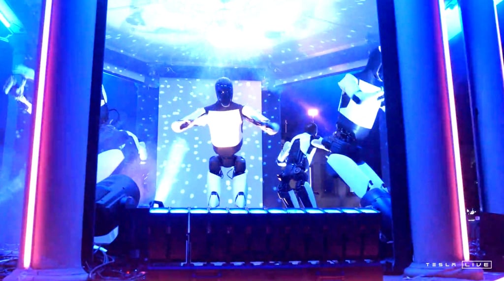 Tesla’s Optimus robots dance at last week’s unveiling event. Photo: Handout via Reuters