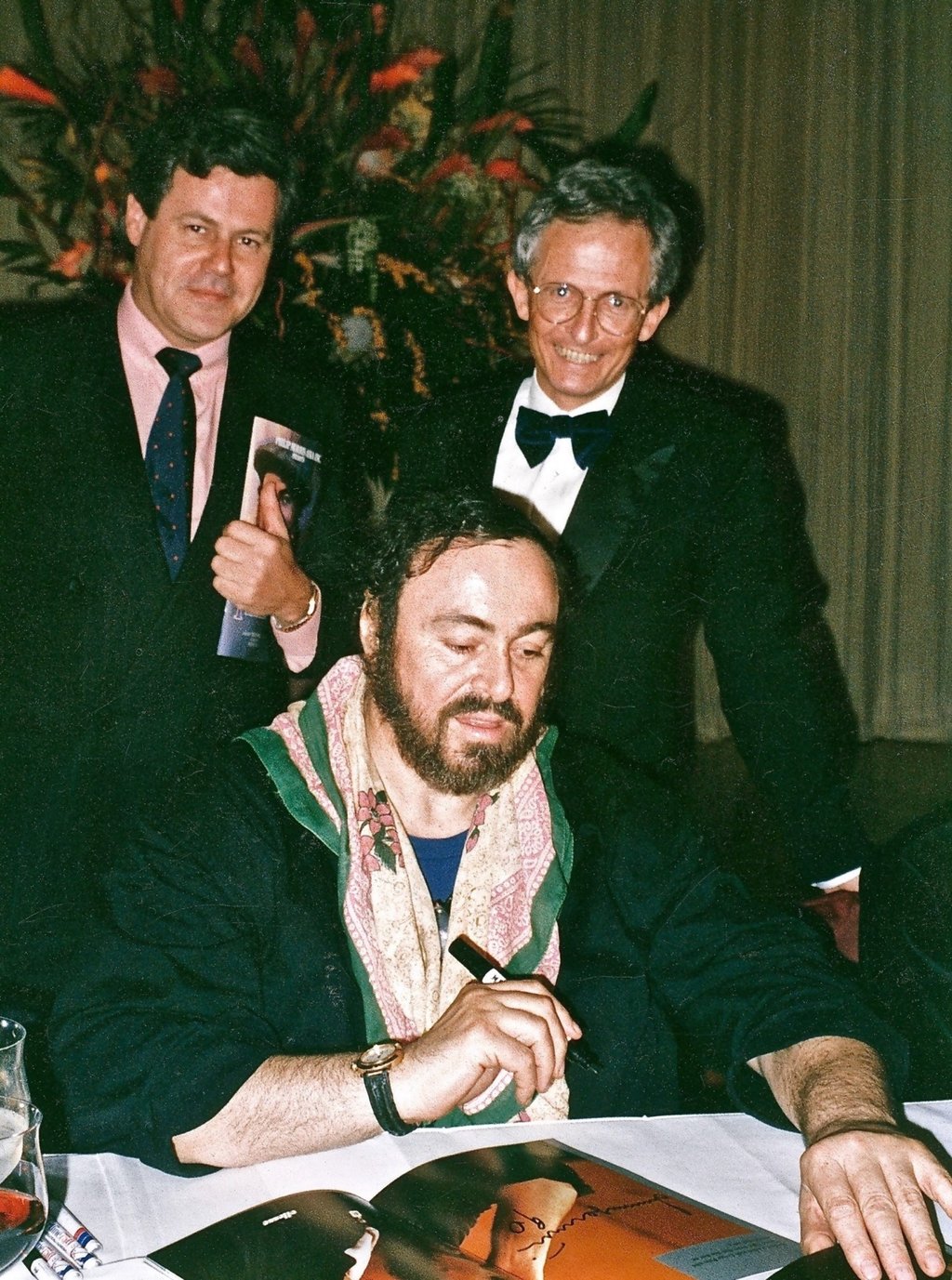 John Duffus (right) with Italian tenor Luciano Pavarotti signing autographs following his first concert in Hong Kong, in 1990. Left is Alastair Blount, the marketing manager of Cathay Pacific. Photo: Blacksmith Books