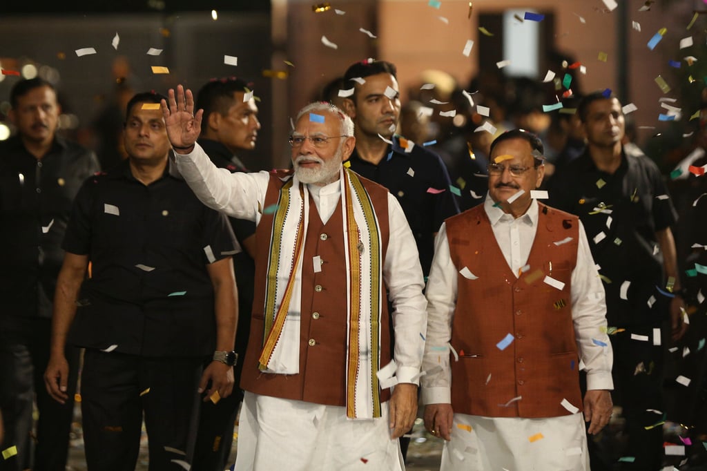 Indian Prime Minister Narendra Modi, left, waves as he arrives to celebrate the election results of northern state of Haryana at BJP headquarters in New Delhi on October 8. Photo: AP Indian Prime Minister Narendra Modi, left, waves as he arrives to celebrate the election results of northern state of Haryana at BJP headquarters in New Delhi on October 8. Photo: AP