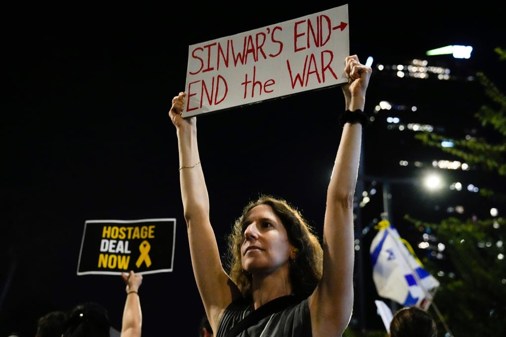 A demonstrator holds a sign about the killing of Hamas leader Yahya Sinwar during a protest in Tel Aviv, Israel, on Thursday. Photo: AP A demonstrator holds a sign about the killing of Hamas leader Yahya Sinwar during a protest in Tel Aviv, Israel, on Thursday. Photo: AP