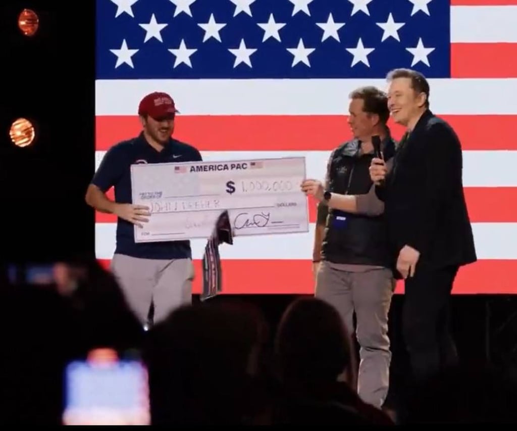Musk awards a US$1 million cheque to John Dreher, an attendee of his event in Pennsylvania on Saturday aimed at rallying supporters behind Trump. Photo: X/America