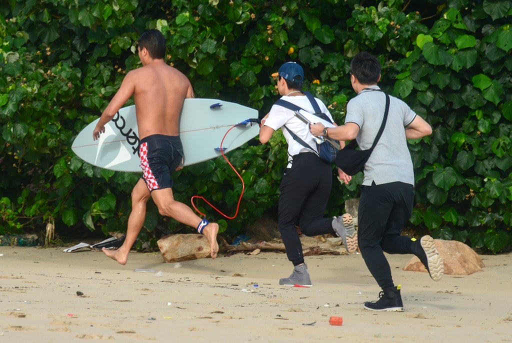 A surfer is chased by staff members of the Leisure and Cultural Services Department at Shek O beach as Super Typhoon Yagi skirts Hong Kong on September 5. Photo: Antony Dickson A surfer is chased by staff members of the Leisure and Cultural Services Department at Shek O beach as Super Typhoon Yagi skirts Hong Kong on September 5. Photo: Antony Dickson