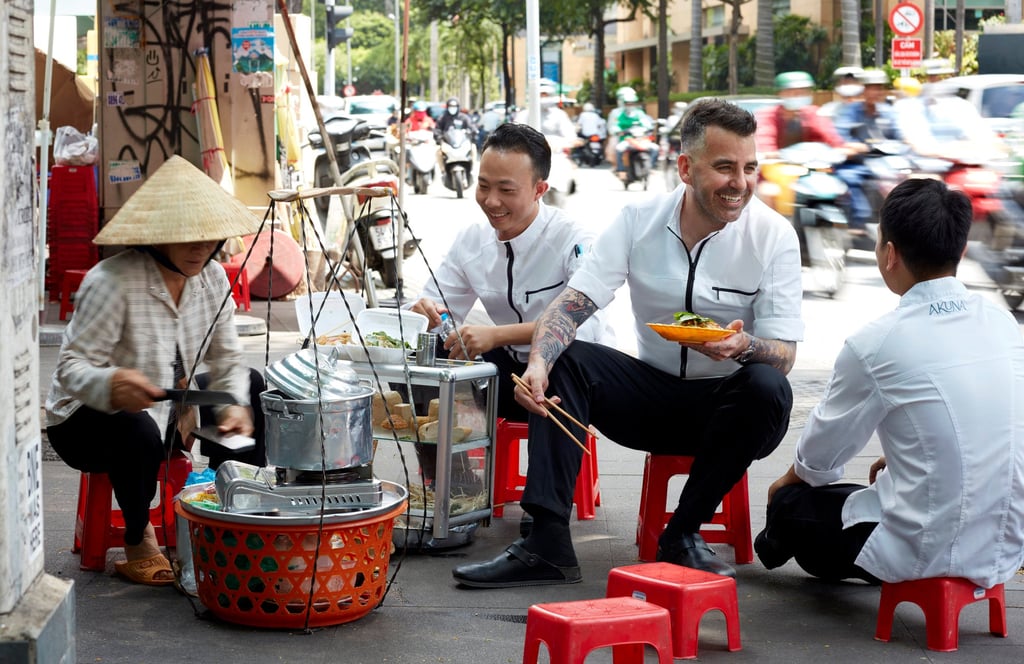 Chef Sam Aisbett (second right) dines out with his team in the streets of Ho Chi Minh City. Photo: Akuna
