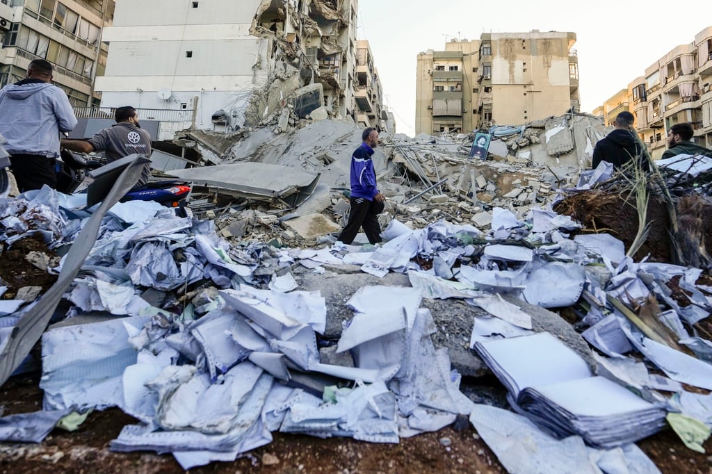 Documents of Hezbollah-run al-Qard al-Hassan are scattered at the site of an Israeli air strike in Beirut’s southern suburbs, Lebanon. Photo: AP Documents of Hezbollah-run al-Qard al-Hassan are scattered at the site of an Israeli air strike in Beirut’s southern suburbs, Lebanon. Photo: AP