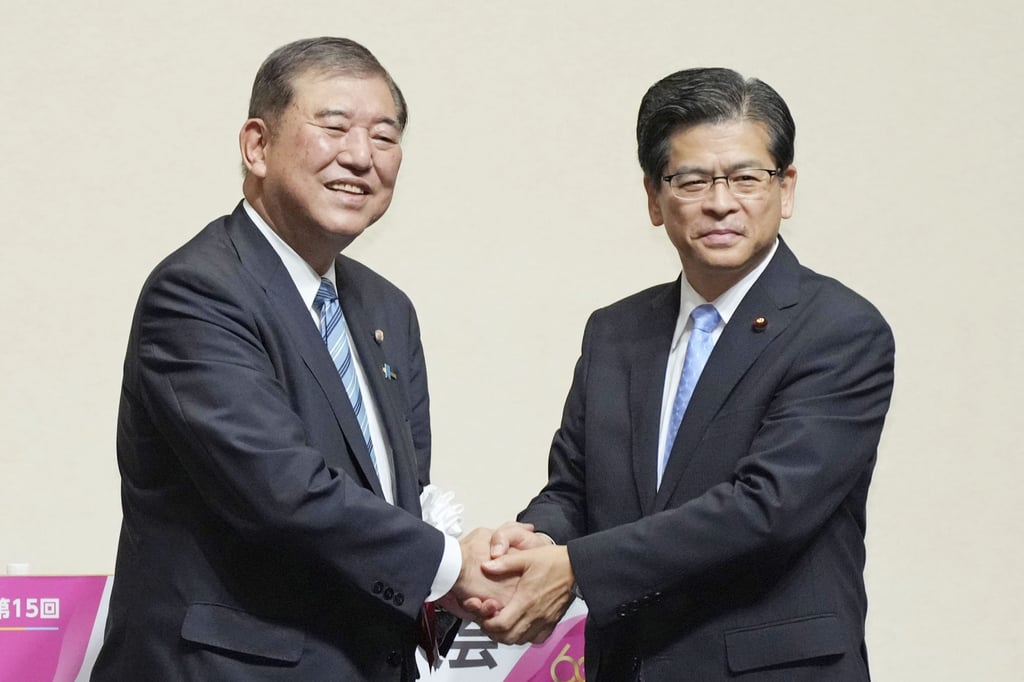 Shigeru Ishiba (left) and Keiichi Ishii, secretary of junior ruling coalition partner Komeito, shake hands at the Komeito party’s convention in Tokyo on September 28. Photo: Kyodo Shigeru Ishiba (left) and Keiichi Ishii, secretary of junior ruling coalition partner Komeito, shake hands at the Komeito party’s convention in Tokyo on September 28. Photo: Kyodo