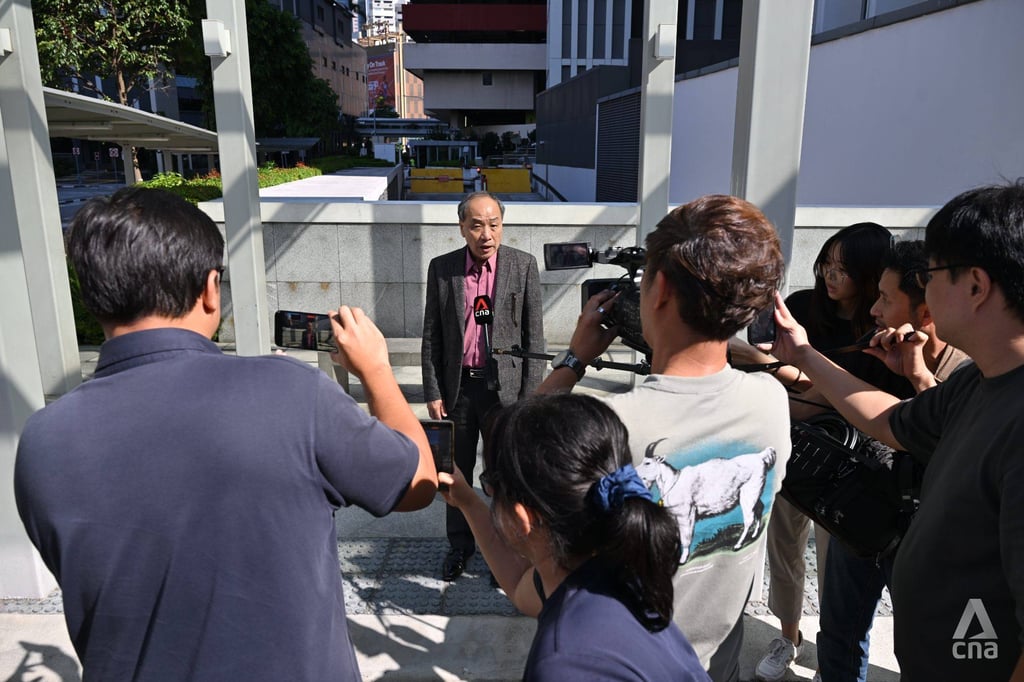 Former Workers’ Party chief Low Thia Khiang is approached by the media as he leaves the State Courts in Singapore on Monday. Photo: Facebook/CNA