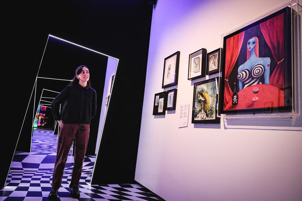 The World of Tim Burton curator Maria McLintock looks at artworks along a corridor of the London exhibition. Photo: AFP The World of Tim Burton curator Maria McLintock looks at artworks along a corridor of the London exhibition. Photo: AFP