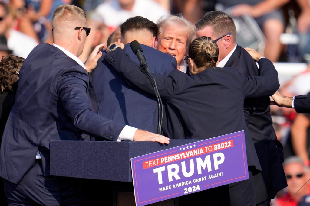 A bloodied Donald Trump is ringed by Secret Service agents after the July assassination attempt against him at a campaign event in Butler, Pennsylvania. Photo: AP Photo A bloodied Donald Trump is ringed by Secret Service agents after the July assassination attempt against him at a campaign event in Butler, Pennsylvania. Photo: AP Photo