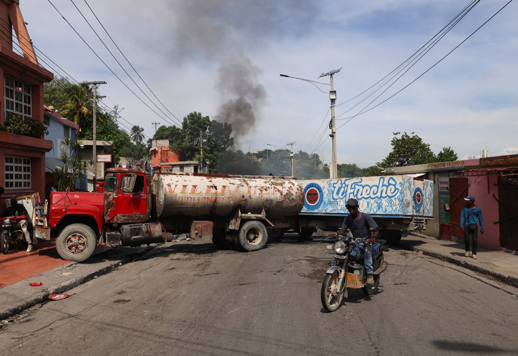 Trucks block a road in Port-au-Prince, Haiti. Photo: Reuters