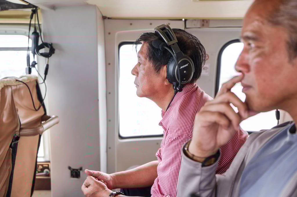 Philippine President Ferdinand Marcos Jr. (left) inspects damage caused by Tropical Storm Trami from a helicopter, on Friday. Photo: AP Philippine President Ferdinand Marcos Jr. (left) inspects damage caused by Tropical Storm Trami from a helicopter, on Friday. Photo: AP
