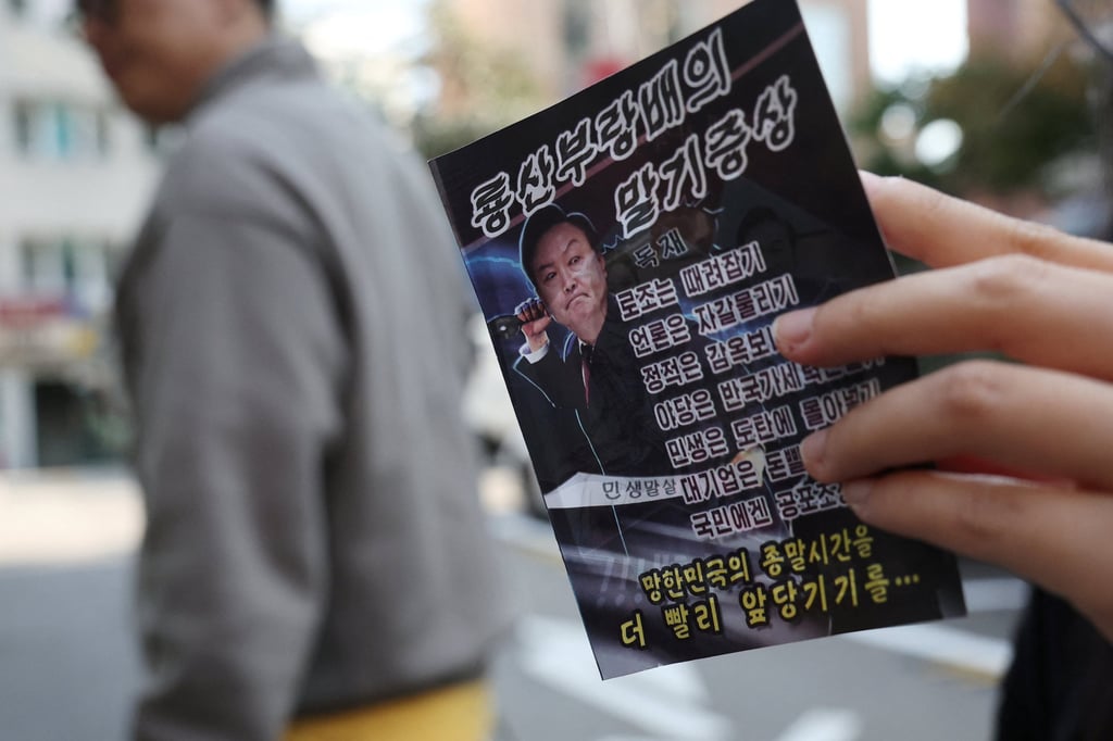 A woman in Seoul looks at a North Korean propaganda leaflet denouncing South Korean President Yoon Suk-yeol, apparently carried over the border by balloon last week. Photo: Reuters A woman in Seoul looks at a North Korean propaganda leaflet denouncing South Korean President Yoon Suk-yeol, apparently carried over the border by balloon last week. Photo: Reuters