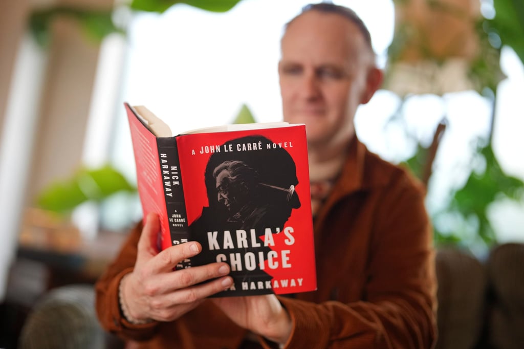British author Nick Harkaway with a copy of his book. Photo: AP