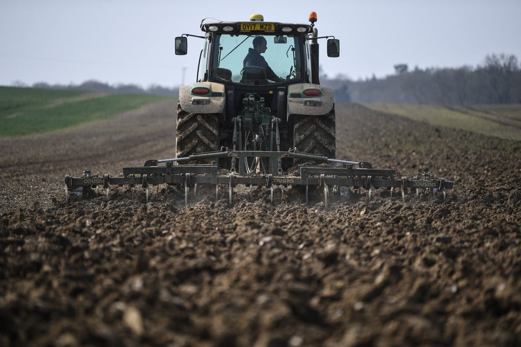 A tractor ploughs soil at a farm in southern England. The UK’s seasonal worker scheme was launched to address agricultural labour shortages post-Brexit. Photo: AFP A tractor ploughs soil at a farm in southern England. The UK’s seasonal worker scheme was launched to address agricultural labour shortages post-Brexit. Photo: AFP