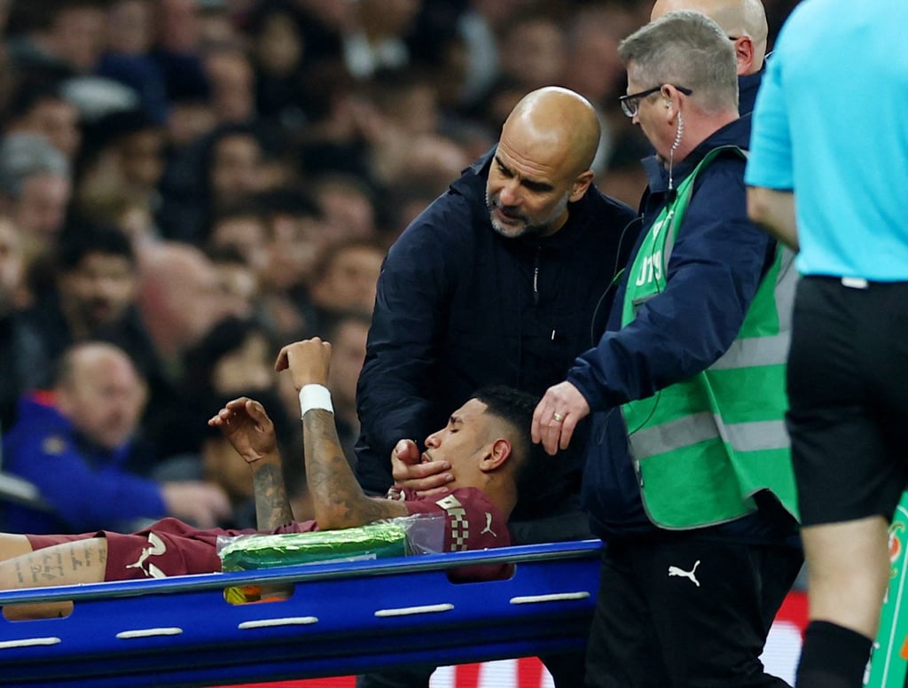 Manchester City boss Pep Guardiola consoles winger Savinho as he is stretchered off. Photo: Reuters Manchester City boss Pep Guardiola consoles winger Savinho as he is stretchered off. Photo: Reuters