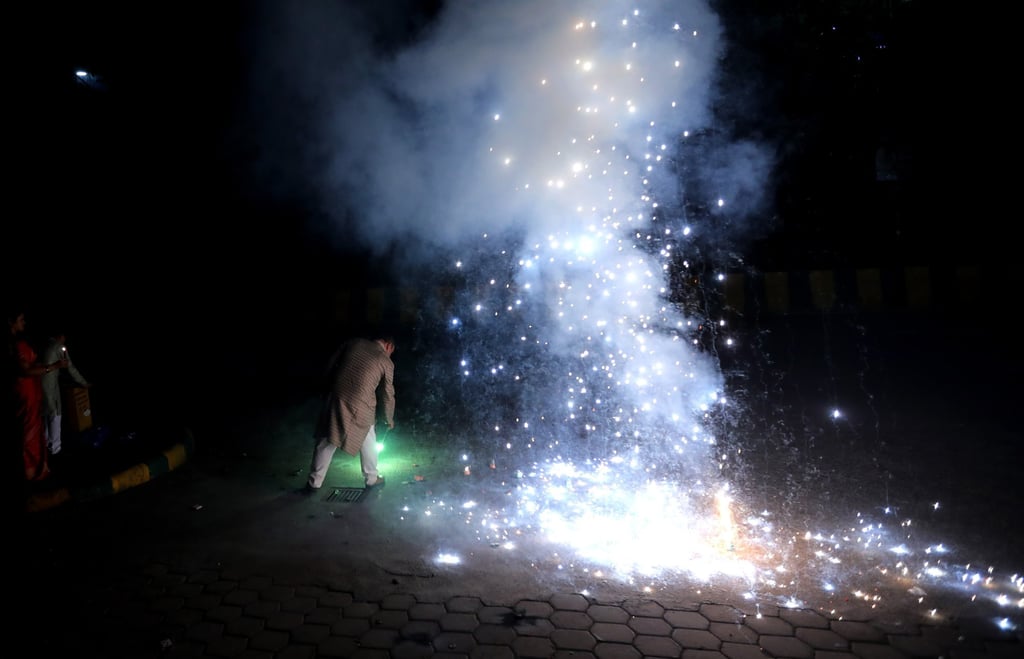 People light sparklers and crackers during Diwali celebrations near New Delhi, India. Photo: EPA-EFE
