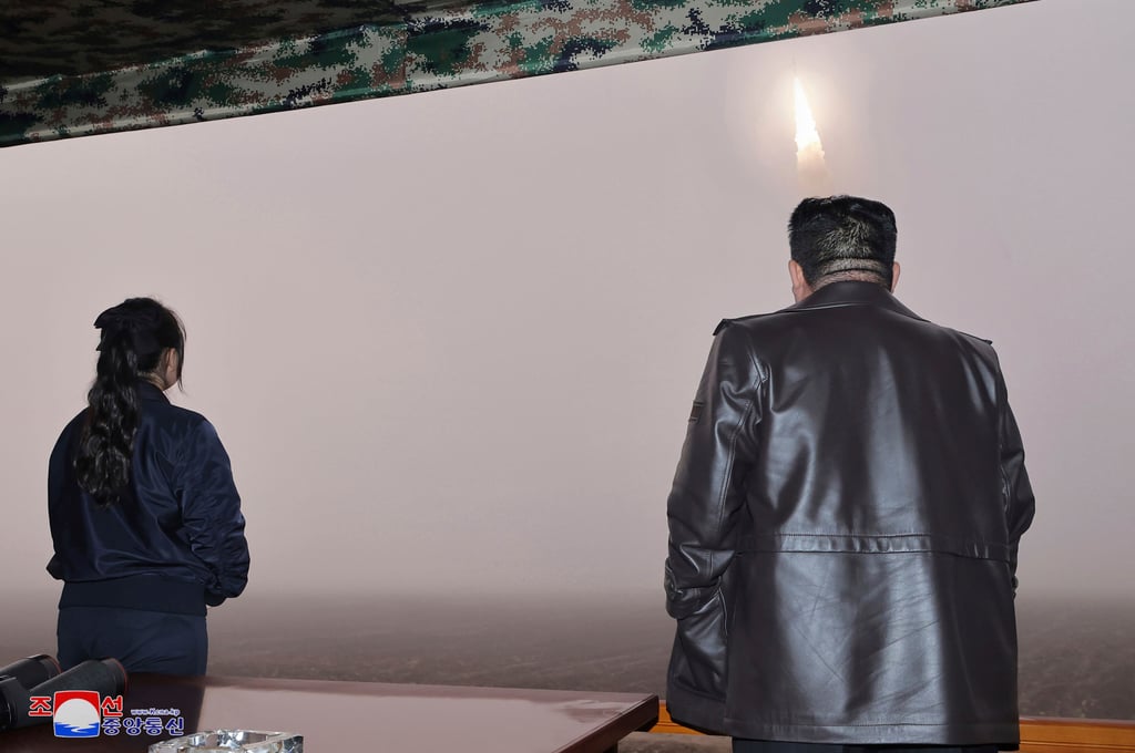 North Korean leader Kim Jong-un, right, and his daughter observe the test launch. Photo: Korea News Service via AP