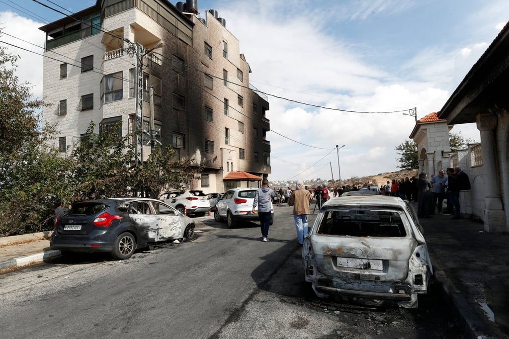 Burnt vehicles at the site of an Israeli settler attack in Al-Bireh near the West Bank city of Ramallh on Monday. Photo: EPA-EFE