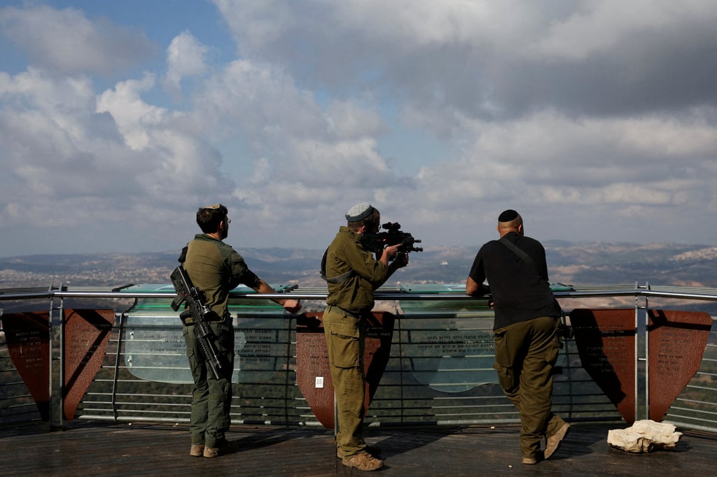 An Israeli soldier looks through the scope of a rifle into southern Lebanon from Israel. Photo: Reuters