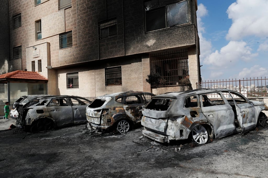 Burnt vehicles at the site where Israeli settlers attacked in Al-Bireh near the West Bank city of Ramallah on Monday. Photo: EPA-EFE Burnt vehicles at the site where Israeli settlers attacked in Al-Bireh near the West Bank city of Ramallah on Monday. Photo: EPA-EFE