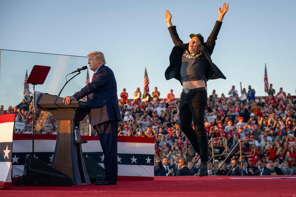 Musk, right, jumps on stage as he joins Republican presidential candidate Donald Trump during a campaign rally in Butler, Pennsylvania last month. Photo: AFP / Getty Images / TNS