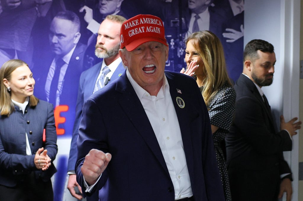 Republican presidential nominee Donald Trump, accompanied by his wife, Melania (centre right), visiting his campaign headquarters in West Palm Beach, Florida, to thank campaign workers on Election Day. Photo: Reuters