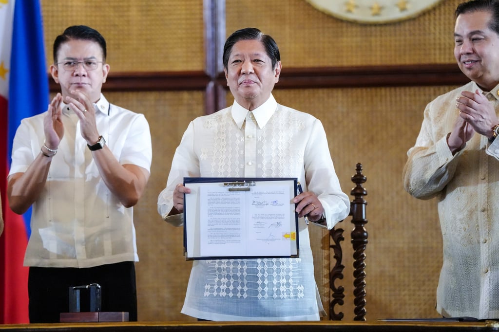 Philippine President Ferdinand Marcos Jnr (centre) during the ceremonial signing of the Maritime Zones Act and Archipelagic Sea Lanes Act, at the presidential palace in Manila on Friday. Photo: Handout via AP Philippine President Ferdinand Marcos Jnr (centre) during the ceremonial signing of the Maritime Zones Act and Archipelagic Sea Lanes Act, at the presidential palace in Manila on Friday. Photo: Handout via AP
