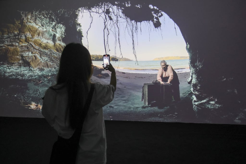 A visitor watches Reihana’s immersive video exhibit, projected on four walls at Tai Kwun’s F Studio. Photo: Edmond So A visitor watches Reihana’s immersive video exhibit, projected on four walls at Tai Kwun’s F Studio. Photo: Edmond So