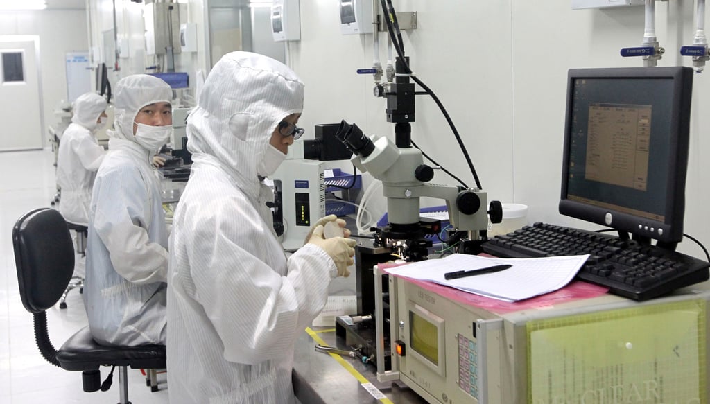 Workers in APT Electronics lab in Nansha, China. Photo: Handout Workers in APT Electronics lab in Nansha, China. Photo: Handout