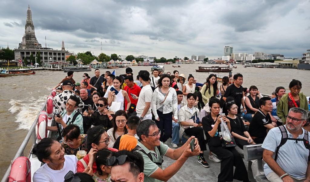 People take a tourist boat on the Chao Praya River in Bangkok. Photo: AFP