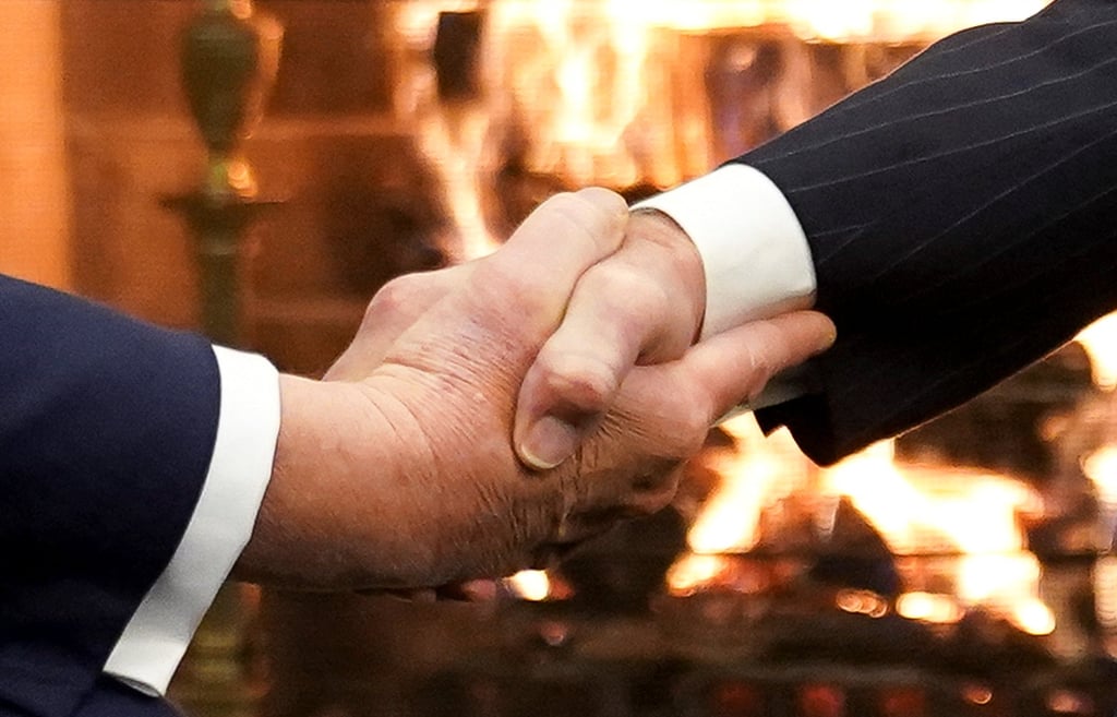 Biden and Trump shaking hands during their meeting. Photo: Reuters