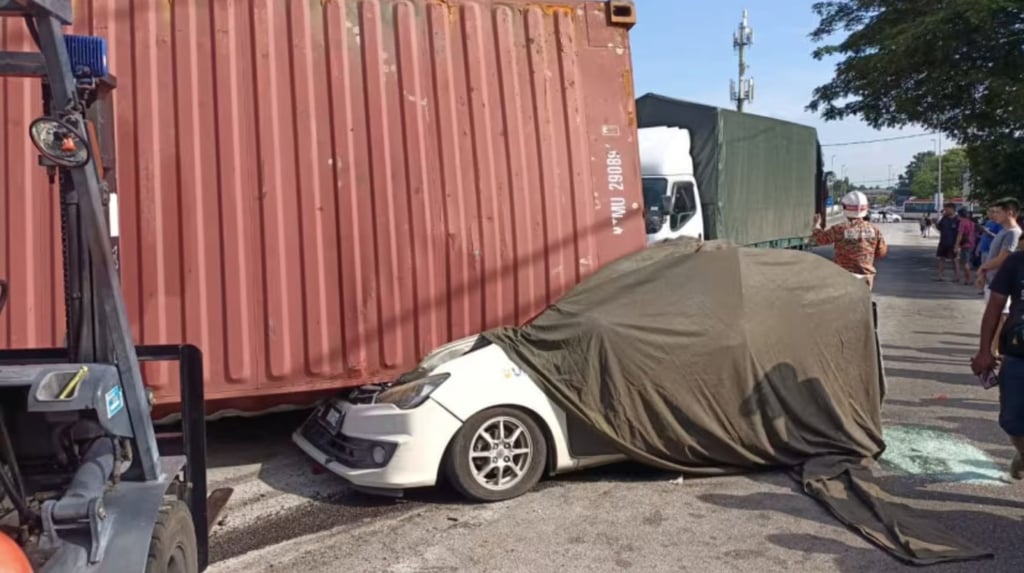 21-year-old Lee Zi Rou was killed when a container rolled off a truck and fell onto her car. Photo: Penang State Fire and Rescue Department