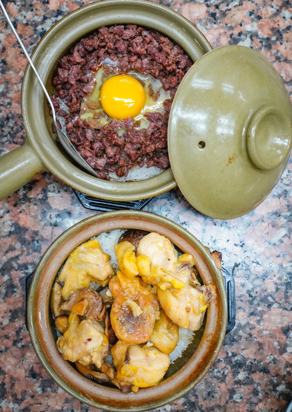 Hand-sliced beef claypot rice with a raw egg and steamed mushroom and chicken claypot rice. Photo: Alexander Mak