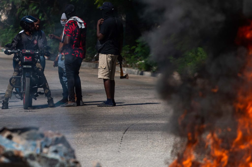 Local residents question a motorist. Photo: AFP Local residents question a motorist. Photo: AFP