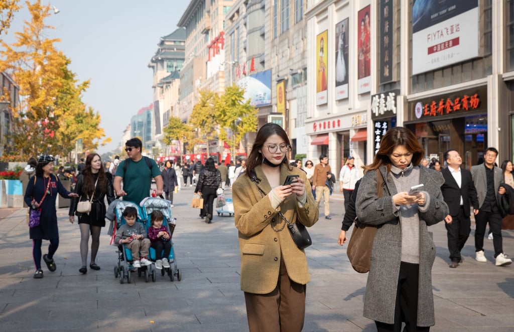 People walk on a shopping street in Beijing. Photo: EPA-EFE