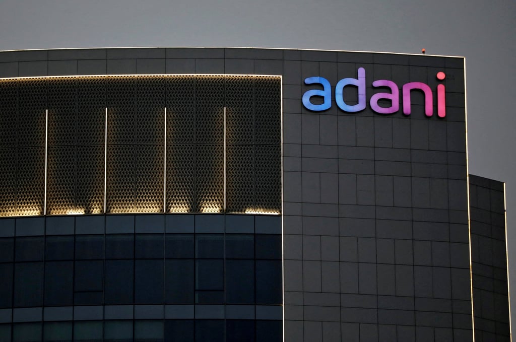 The logo of the Adani Group is seen on the facade of one of its buildings on the outskirts of Ahmedabad, India, in April 2021. Photo: Reuters The logo of the Adani Group is seen on the facade of one of its buildings on the outskirts of Ahmedabad, India, in April 2021. Photo: Reuters
