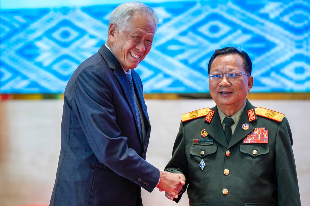 Laos’ Defence Minister Chansamone Chanyalath, right, greets Singaporean Defence Minister Ng Eng Hen during the Asean Defence Ministers’ Meeting in Vientiane, Laos, on November 20. Photo: AP