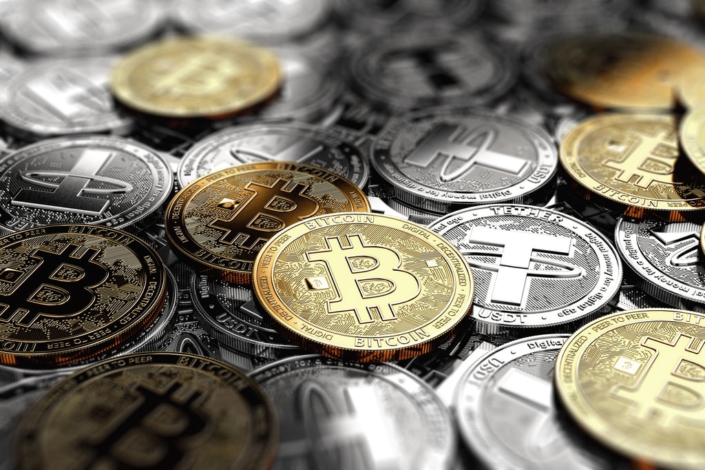 Several bitcoin on a stack of silver Tether coins. Photo: Shutterstock